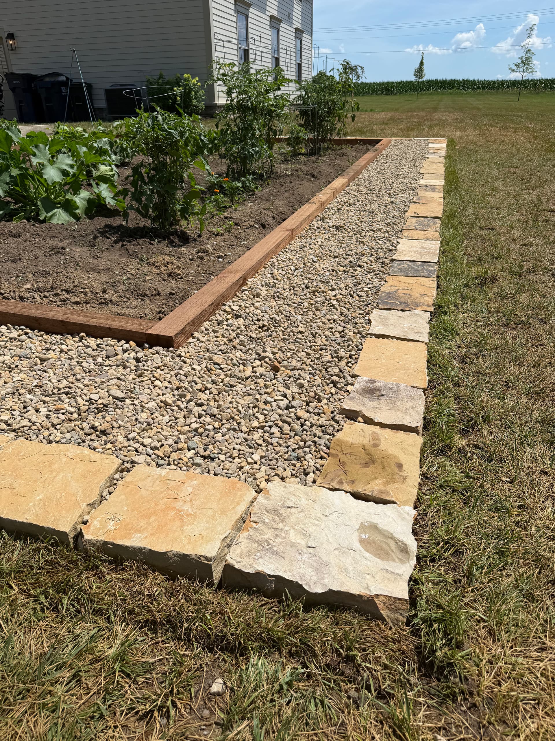 Cedar Raised Beds and Stone Edging Make This Garden Actually Work image